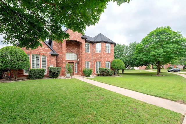 7100 Oakbrook Dr, Plano, TX 75025 - view of front facade featuring brick siding and a front lawn