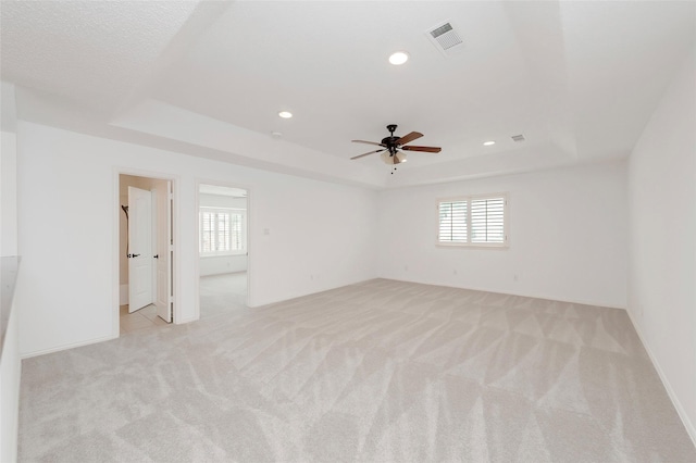 7100 Oakbrook Dr, Plano, TX 75025 - unfurnished room with a tray ceiling, plenty of natural light, light colored carpet, and recessed lighting
