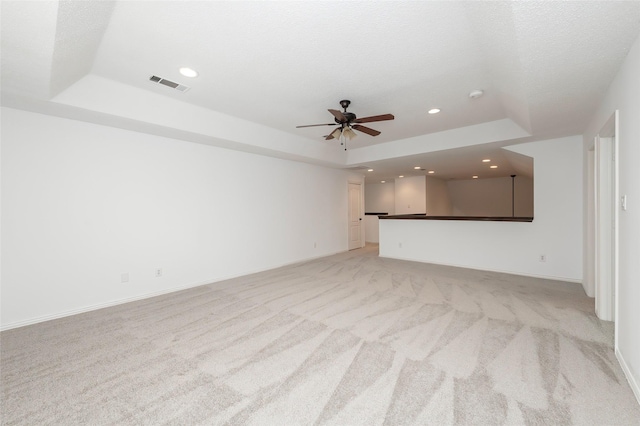7100 Oakbrook Dr, Plano, TX 75025 - unfurnished living room featuring a tray ceiling, light colored carpet, a ceiling fan, recessed lighting, and baseboards
