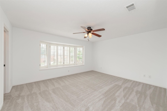 7100 Oakbrook Dr, Plano, TX 75025 - unfurnished room with a ceiling fan, light colored carpet, and baseboards