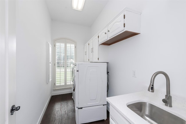 7100 Oakbrook Dr, Plano, TX 75025 - laundry area featuring cabinet space, washer / dryer, dark wood-style floors, and baseboards