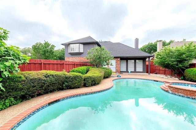 7100 Oakbrook Dr, Plano, TX 75025 - view of pool with a fenced backyard and a pool with connected hot tub