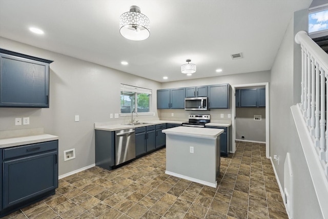 kitchen featuring appliances with stainless steel finishes, a sink, baseboards, recessed lighting, and light countertops