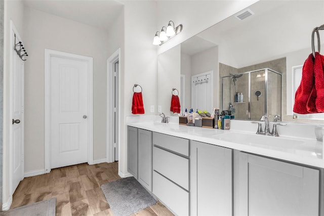 7225 Tesoro Trl, Fort Worth, TX 76131 - bathroom with a stall shower, double vanity, and wood finished floors
