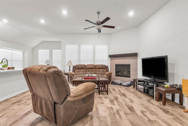 7225 Tesoro Trl, Fort Worth, TX 76131 - living room with a ceiling fan, light wood-type flooring, recessed lighting, a tile fireplace, and vaulted ceiling