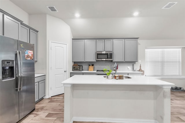 7225 Tesoro Trl, Fort Worth, TX 76131 - kitchen with appliances with stainless steel finishes, gray cabinets, backsplash, light countertops, and vaulted ceiling