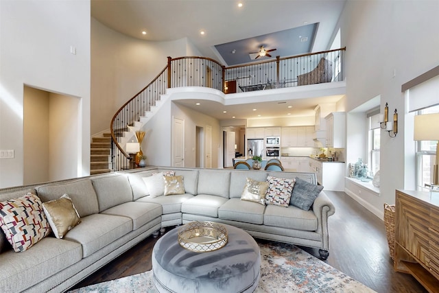 16175 Barton Creek Ln, Frisco, TX 75033 - living room featuring a towering ceiling, ceiling fan, dark wood-type flooring, stairs, and recessed lighting