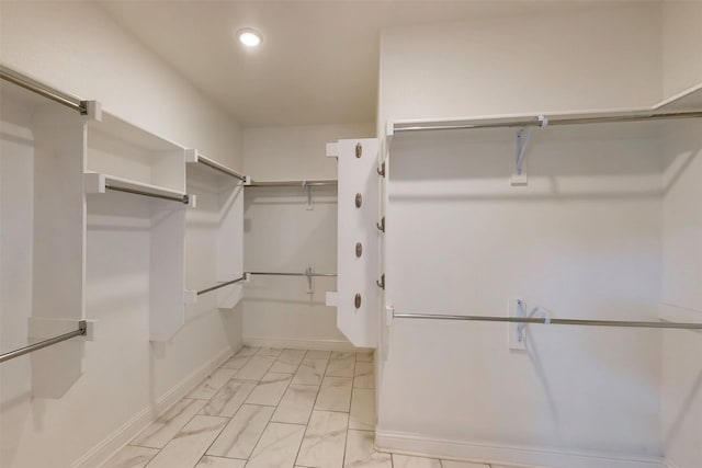 16175 Barton Creek Ln, Frisco, TX 75033 - walk in closet featuring light marble finish floors