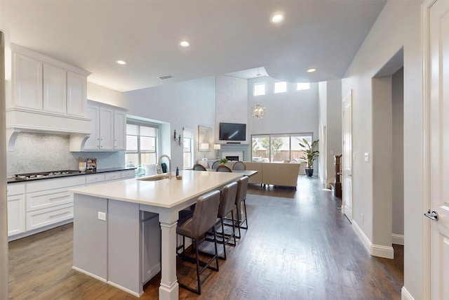 16175 Barton Creek Ln, Frisco, TX 75033 - kitchen with a sink, healthy amount of natural light, backsplash, an island with sink, and recessed lighting
