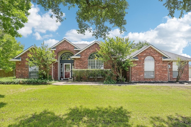 view of front of property with a front lawn and brick siding