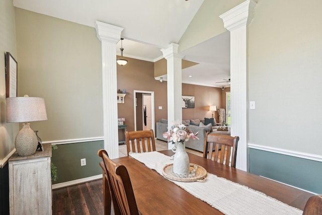 dining room featuring decorative columns, wood finished floors, a ceiling fan, vaulted ceiling, and baseboards
