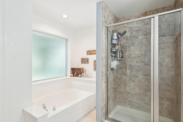 full bath featuring a shower stall, a garden tub, and tile patterned floors