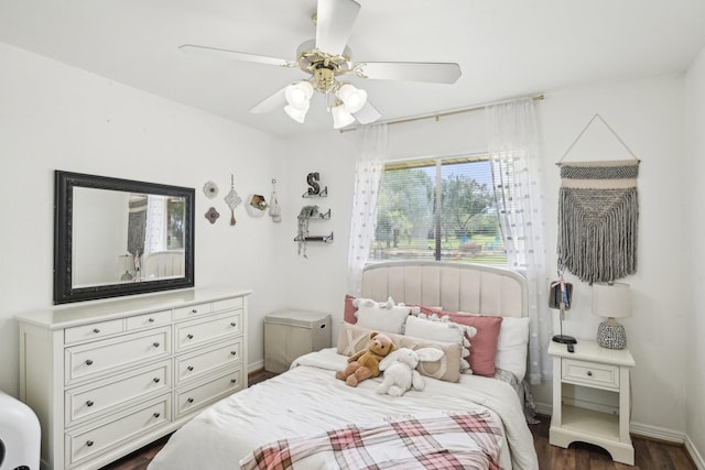 bedroom featuring dark wood-style flooring, baseboards, and a ceiling fan