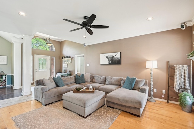 living room with ornate columns, hardwood / wood-style flooring, baseboards, a ceiling fan, and ornamental molding