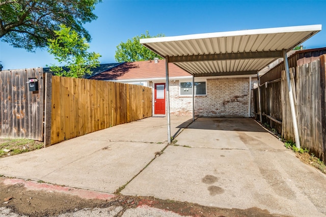 22 W Mountain Ln Unit 42, Grand Prairie, TX 75052 - view of patio with fence, driveway, and a detached carport