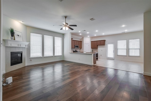 15429 Pioneer Bluff Trl, Fort Worth, TX 76262 - unfurnished living room featuring a ceiling fan, plenty of natural light, wood finished floors, baseboards, and recessed lighting
