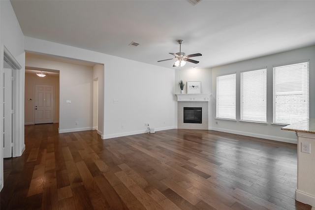 15429 Pioneer Bluff Trl, Fort Worth, TX 76262 - unfurnished living room featuring a ceiling fan, dark wood-style floors, a tile fireplace, and baseboards