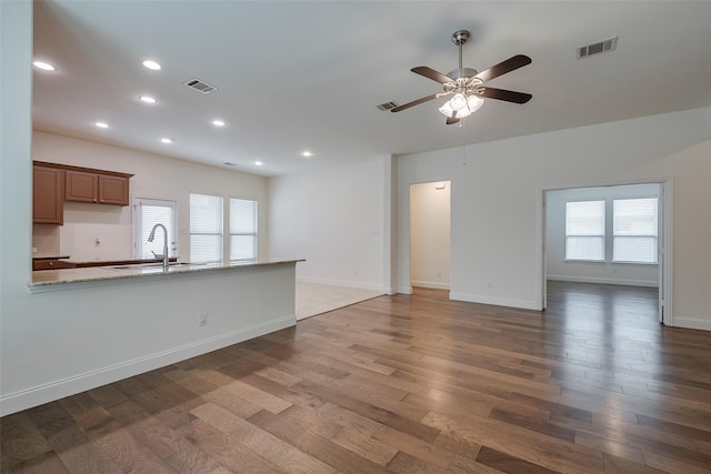 15429 Pioneer Bluff Trl, Fort Worth, TX 76262 - unfurnished living room featuring wood finished floors, a sink, ceiling fan, plenty of natural light, and recessed lighting