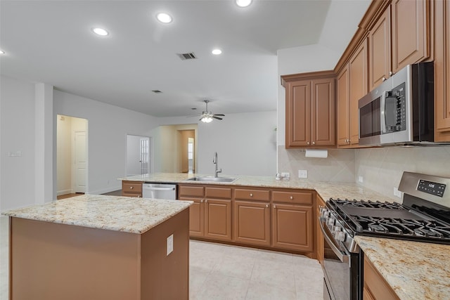 15429 Pioneer Bluff Trl, Fort Worth, TX 76262 - kitchen with appliances with stainless steel finishes, a sink, a peninsula, a center island, and decorative backsplash