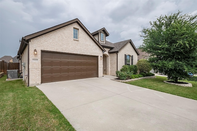15429 Pioneer Bluff Trl, Fort Worth, TX 76262 - view of front facade featuring brick siding, concrete driveway, central AC unit, and an attached garage