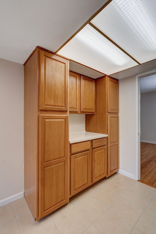 932 Goodwin Dr, Plano, TX 75023 - kitchen featuring baseboards, light tile patterned flooring, and light countertops