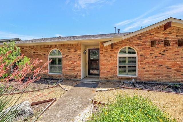 932 Goodwin Dr, Plano, TX 75023 - doorway to property with brick siding and roof with shingles