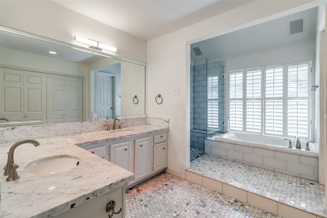 bathroom with plenty of natural light, double vanity, and tile patterned floors