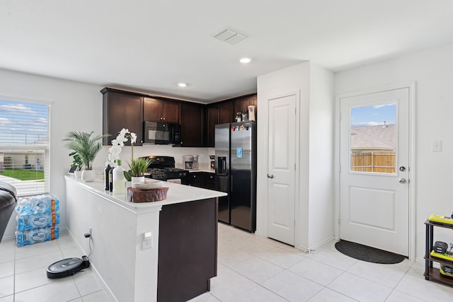 301 Dry Canyon Way, Fort Worth, TX 76052 - kitchen featuring black appliances, dark brown cabinetry, light countertops, a peninsula, and light tile patterned floors