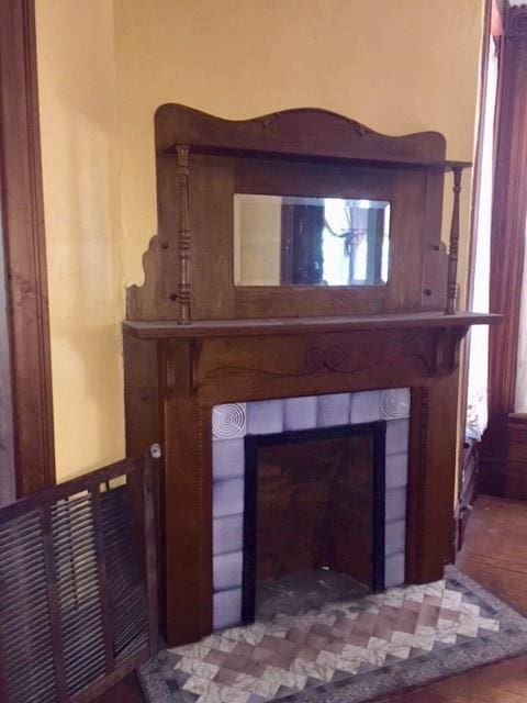 211 N Pleasant St, Hillsboro, TX 76645 - detailed view of a tiled fireplace and wood finished floors