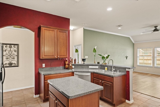 kitchen featuring stainless steel dishwasher, ornamental molding, a sink, a ceiling fan, and a kitchen island