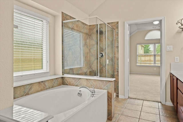 full bath featuring vaulted ceiling, a stall shower, a bath, and vanity