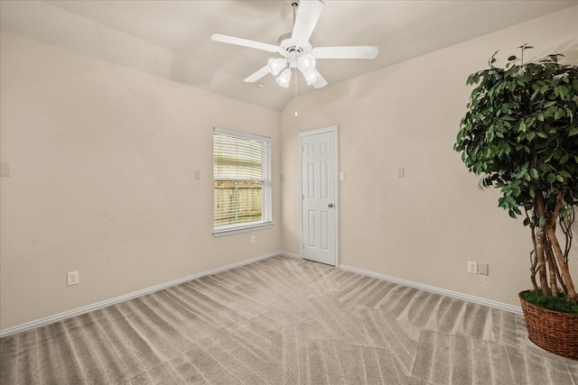 empty room featuring light colored carpet, baseboards, and ceiling fan