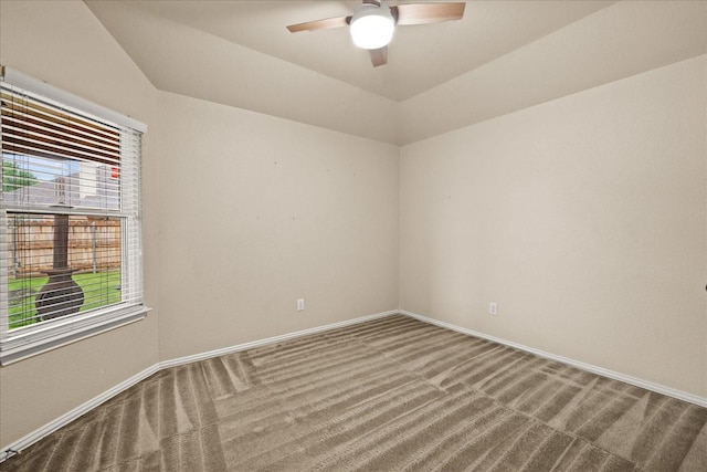 carpeted spare room featuring ceiling fan and baseboards