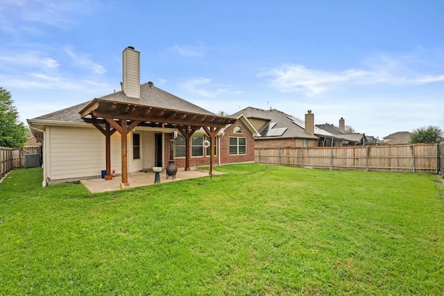 rear view of property with a patio area, a chimney, and brick siding