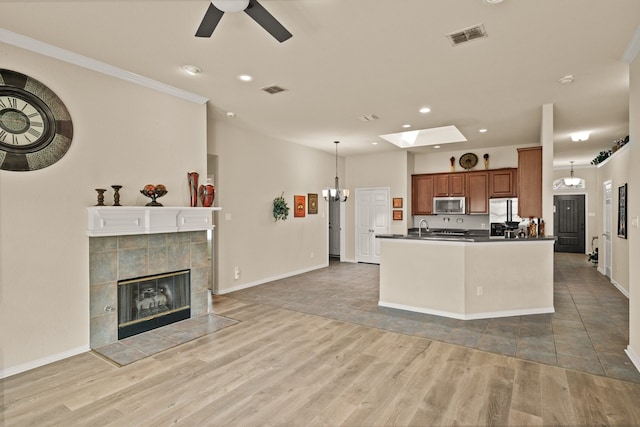 3305 Francis Dr, Wylie, TX 75098 - kitchen featuring appliances with stainless steel finishes, dark countertops, brown cabinets, a ceiling fan, and recessed lighting