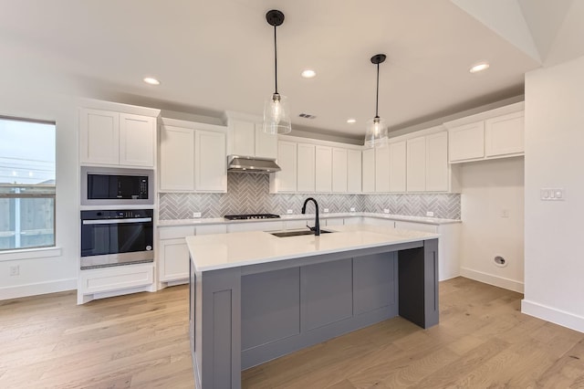 1717 Truro Ln, Fort Worth, TX 76052 - kitchen featuring oven, a sink, black microwave, decorative backsplash, and under cabinet range hood