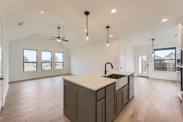 1717 Truro Ln, Fort Worth, TX 76052 - kitchen with a sink, a ceiling fan, gray cabinets, light countertops, and an island with sink