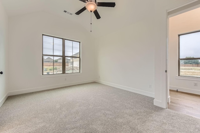 1717 Truro Ln, Fort Worth, TX 76052 - spare room featuring light carpet, healthy amount of natural light, vaulted ceiling, ceiling fan, and baseboards