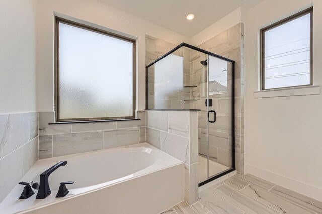 1717 Truro Ln, Fort Worth, TX 76052 - bathroom featuring plenty of natural light, a bath, a stall shower, marble look tiles, and recessed lighting
