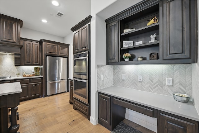 kitchen with stainless steel appliances, light countertops, decorative backsplash, dark brown cabinets, and open shelves
