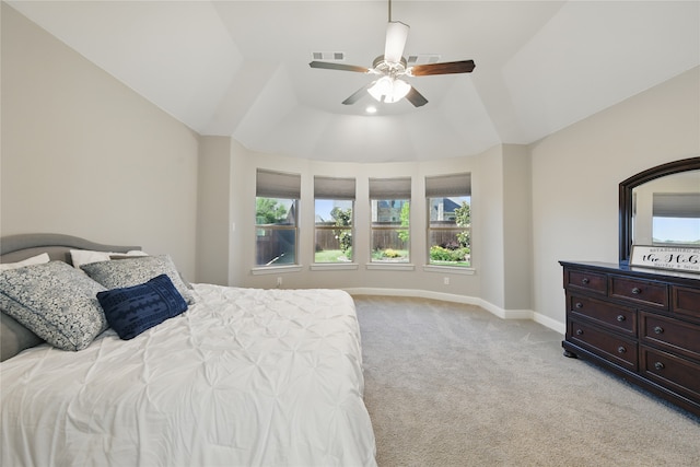 bedroom featuring light colored carpet, baseboards, and a ceiling fan