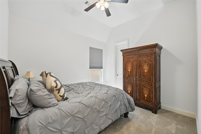 bedroom featuring light colored carpet, lofted ceiling, a ceiling fan, and baseboards