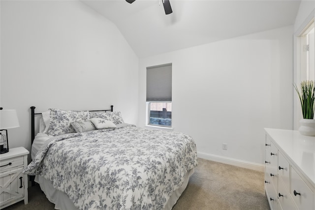 carpeted bedroom with lofted ceiling, baseboards, and ceiling fan
