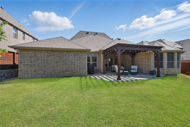 rear view of house with a pergola, a patio area, brick siding, and roof with shingles