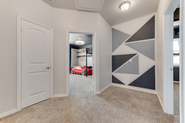 hall featuring carpet, lofted ceiling, and baseboards
