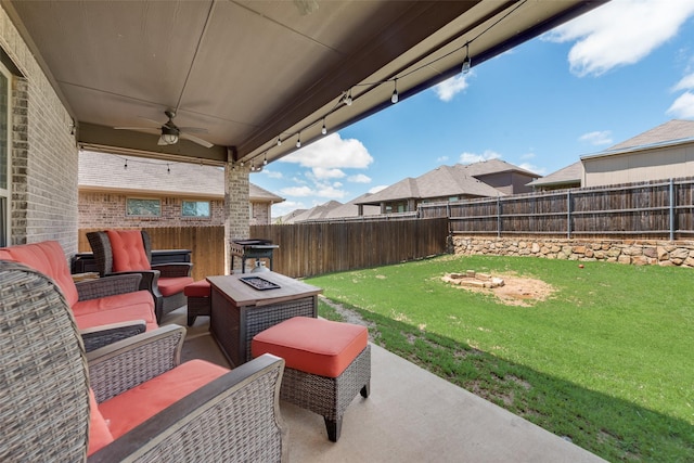 view of patio / terrace with an outdoor living space with a fire pit and ceiling fan
