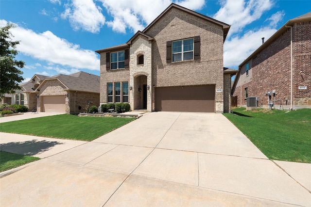 view of front of house featuring brick siding, driveway, central AC unit, and a front lawn