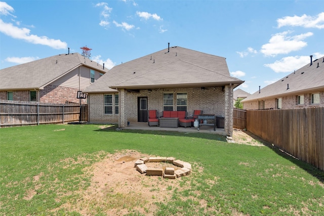 rear view of property featuring an outdoor living space, a patio, and brick siding