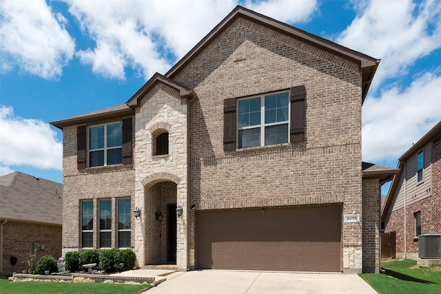 french country style house featuring brick siding, an attached garage, and central AC unit