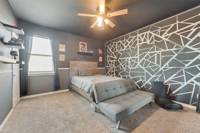 carpeted bedroom with baseboards and a ceiling fan